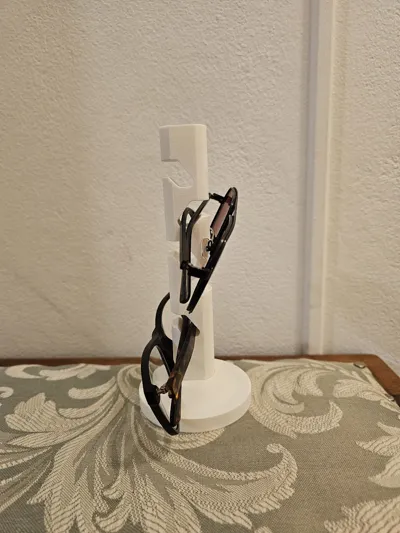 White single-tower 3D-printed sunglasses stand holding two pairs of glasses